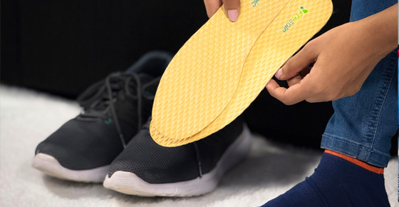 girl-on-couch-holding-insoles