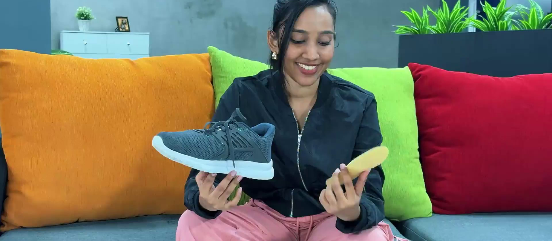 girl-inserting-insole-into-shoe-on-couch-mobile